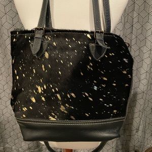 Myra Bag. Black, furry on one side with gold splatters.